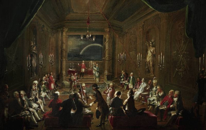 Innenansicht der Wiener Freimaurerloge «Zur gekrönten Hoffnung». Ganz rechts Mozart im Gespräch mit Emanuel Schikaneder (im roten Mantel). Gemälde, um 1790, anonym. Öl auf Leinwand, Wien Museum.